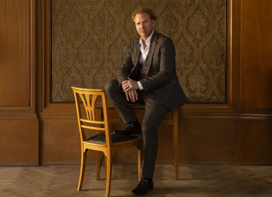 Daniel Hope in brown suit without violin.