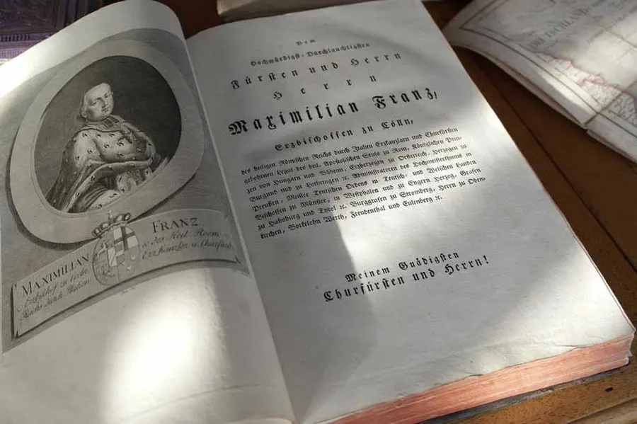 Open book with engraved portrait of Elector Maximilian Franz, Beethoven's Bonn employer and patron.