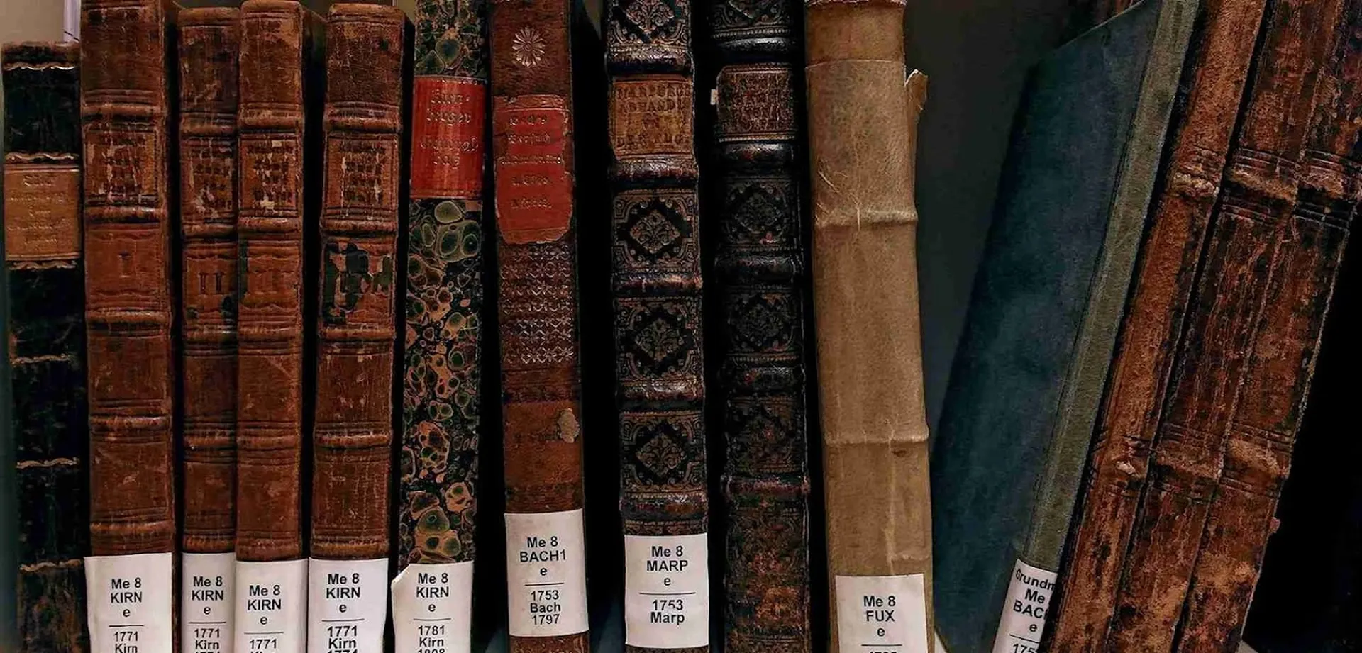 Old books back to back. The signature labels indicate the location in the library of the Beethoven-Haus.