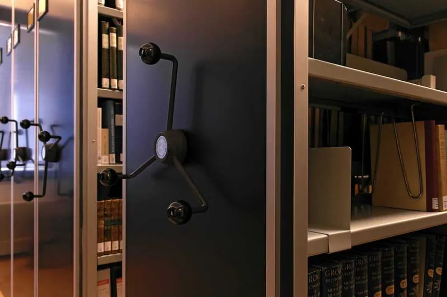 View of a library stacks. Most of the holdings are stored on mobile shelves.
